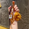 Cute pretzel plush keychain with braided paracord ropes, trendy bag charm accessory. - Pretzel