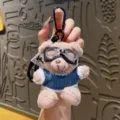 Cute plush pilot bear keychain with cool aviator goggles and blue sweater bag charm. - Blue Shirt Bear