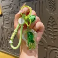 Creative green oil-filled floating quicksand bottle keychain acrylic bag charm ornament - Astronaut / Green