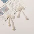 Elegant long pearl pendant earrings with iridescent bow DIY handmade beaded design for women. - Glitter White