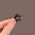 Vue détail de mini pince à cheveux étoile noire en strass, accessoire de coiffure chic. - Mini Pince Étoile (MG-A0067)