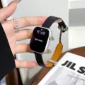 Detailed close-up of leather watch strap for smartwatch, elegant metal magnetic clasp design. - Silver Black