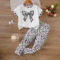Detailed view of girl's summer outfit featuring leopard print bow top and matching leggings - 2-3Y / Top And Bottom
