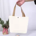 Strapazierfähige weiße Canvas-Einkaufstasche mit khakifarbenen Griffen und Druckknopf - Brauner Griff Leeres Modell / 27*22*10cm