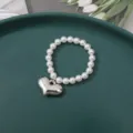 Elegant pearl bracelet featuring a chunky silver heart pendant for women and girls. - 6mm Small Flat Heart Bead (1 Piece)