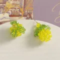 Detailed close-up shot of handmade crystal glass bead fruit charms, DIY jewelry making parts. - Single Yellow