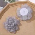 Close-up detail view of grey organza burnt edge flower DIY handmade craft accessory. - Gray