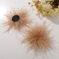 Detailed view of fluffy beige ostrich feather flower DIY hair accessory and craft material. - Brown