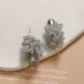 Detailed close-up of handmade beaded crystal pinecone pendants with faceted drops. - Gray