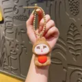 Cute cartoon rabbit squeeze keychain toy, soft silicone bag pendant with heart, stress relief item. - Brown