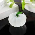 Detailed close-up of a frosted white glass pumpkin figurine with a green stem for autumn decor. - Matte White