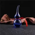 Blue crystal gourd ornament detail view, feng shui home decor piece with red ribbon decor. - Blue