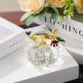 Exquisite crystal pumpkin ornament detail view with elegant gold vine and butterfly decors. - 5cm / Clear