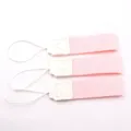 Close-up detail of pink portable cup handle straps with white elastic loops and PU leather patch. - Pink