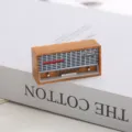 Detailed close-up product view of a miniature 1:12 scale dollhouse vintage radio model prop. - Yellow Radio