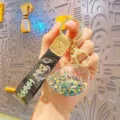 Cute cartoon oil-filled floating glitter whale keychain, stylish metal ring bag accessory charm. - Black