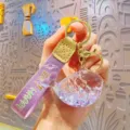 Cute purple whale floating liquid keychain with sparkling glitter, stylish keyring accessory. - Purple