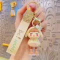 Cute electroplated cosplay girl cartoon keychain pendant with strap and metal ring accessory. - Yellow