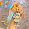 Cute cartoon girl keychain with blue lanyard, metal ring, stylish bag charm and accessory. - Blue