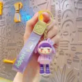 Cute cartoon girl keychain with purple strap and metal ring, perfect bag pendant charm. - Purple