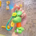 Cute cartoon dinosaur keychain with telescopic neck and kiwi charm for backpack bag - Orange