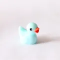 Detail view of cute mini resin duck figurine, candy blue color, ideal for micro landscape decor. - Candy Blue