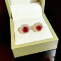 Elegant round red gemstone stud earrings with sparkling white cubic zirconia halo in gold tone. - Gold Red Round Zirconia Stud Earrings (D223)