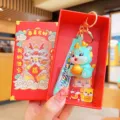 Cute cartoon dragon keychain with gold ingot in red gift box, perfect new year souvenir gift. - Blue Dragon With Gift Box / Blue