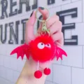 Red fluffy devil plush keychain with bat wings, cute cartoon doll bag charm for keys. - Red