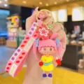 Cute cartoon girl keychain bag pendant, pink braided doll charm with flower strap for gifts. - Pink