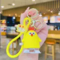 Cute cartoon wind-up chick keychain, vibrant yellow color with strap and metal rings. - Yellow Chick