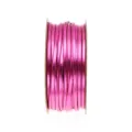 Close-up of metallic pink PU leather cord rolled on spool for DIY jewelry crafting accessories. - Rose Red