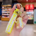 Colorful cute cartoon monster keychain bag charm with metal ring and yellow strap. - Iridescent Cabbage Man / Champagne