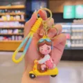 Cute cartoon girl scooter keychain, yellow braided strap, lovely bag accessory and car key ring. - Yellow Vehicle Girl
