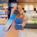 Cute blue bear keychain with gradient strap and metal clasp, perfect backpack and bag charm accessory. - Blue