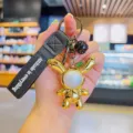 Llavero de conejo de orejas largas chapado en oro con correa negra para bolso. - Conejo Irisado - Dorado