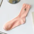 Cute pink mid-calf socks for women featuring delicate tulip embroidery and ruffle lace cuff. - One Size / Pink