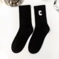 Black crew socks with white embroidered letter C design, cozy retro casual cotton socks for women. - One Size / Letter C / Black