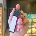 Cute bow tie bear resin keychain with black strap and pink leather tag for car keys bag charm. - Resin Style (Little Bear A665) / Pink Nordic Bear