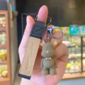 Grey resin cartoon bear keychain with a stylish black leather strap and metal clasp. - Brown Nordic Bear