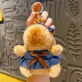Cute Capybara plush keychain with denim dress and brown bow, soft bag charm accessory. - Denim Skirt Style