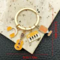 Music theme metal keychain with guitar, headphone, keyboard and microphone charms. - Music Key Ring (LS129) / 1 Piece (9.0g)