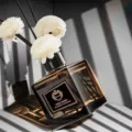 Exquisite square glass reed diffuser bottle with white flower sticks, ideal for home fragrance. - Westin White Tea (Hotel Scent)