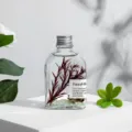 Glass bottle reed diffuser with glowing stones and red twig decor for home fragrance. - 200ml / Freesia