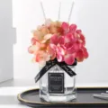 Hydrangea reed diffuser set with 50ml home fragrance oil in glass bottle and pink flowers. - Encounter - 50ml