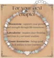 Detailed view of adjustable beaded bracelet with Moonstone and heart charm on gift card - For Your Next Chapter Theme