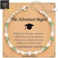 Handmade graduation beaded bracelet with a silver heart charm on a paper gift card - The Adventure Begins - Green Stone Heart