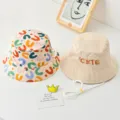 Kids double-sided sun protection bucket hat with cute embroidery and adjustable chin strap. - 52cm / Beige