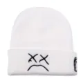 White knit beanie for winter, featuring embroidered sad face and XX eyes design for streetwear style. - White