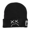 Black knitted beanie hat with white embroidered sad face design, casual winter warm cap. - Black